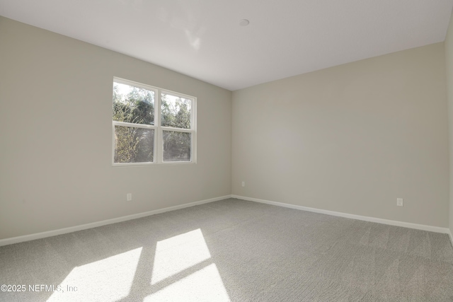 empty room with carpet floors and baseboards