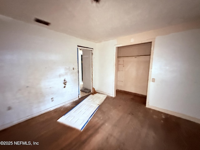 unfurnished bedroom featuring a closet and baseboards