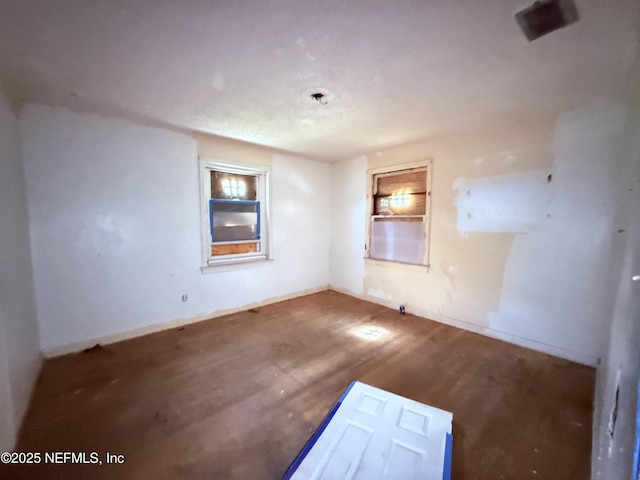 spare room featuring wood finished floors