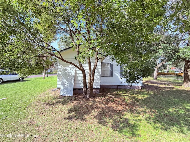 view of home's exterior with a lawn