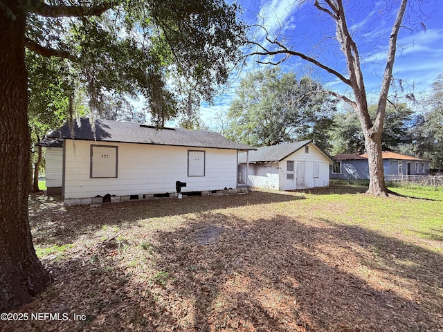 back of house with a lawn