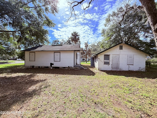 back of property featuring a yard