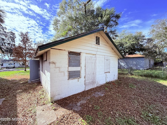 view of outbuilding with fence