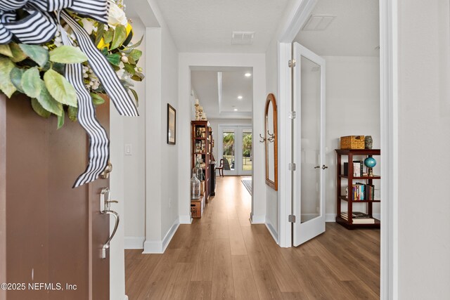 93322 Sandown Dr, Fernandina Beach, FL 32034 - foyer with french doors, wood finished floors, baseboards, and recessed lighting
