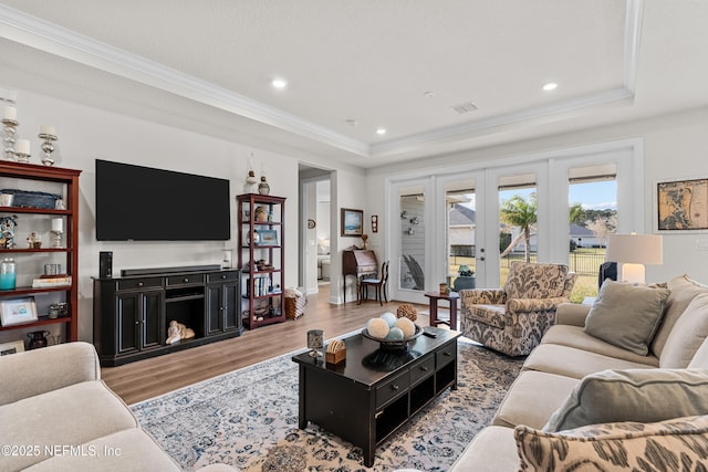 93322 Sandown Dr, Fernandina Beach, FL 32034 - living room with wood finished floors, a tray ceiling, crown molding, recessed lighting, and a wall mounted air conditioner