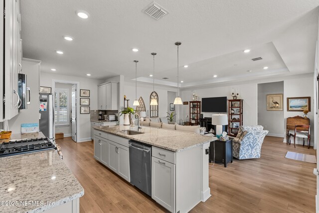 93322 Sandown Dr, Fernandina Beach, FL 32034 - kitchen with stainless steel appliances, a sink, open floor plan, baseboards, and pendant lighting