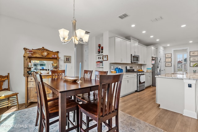93322 Sandown Dr, Fernandina Beach, FL 32034 - dining area with a chandelier, light wood finished floors, and recessed lighting