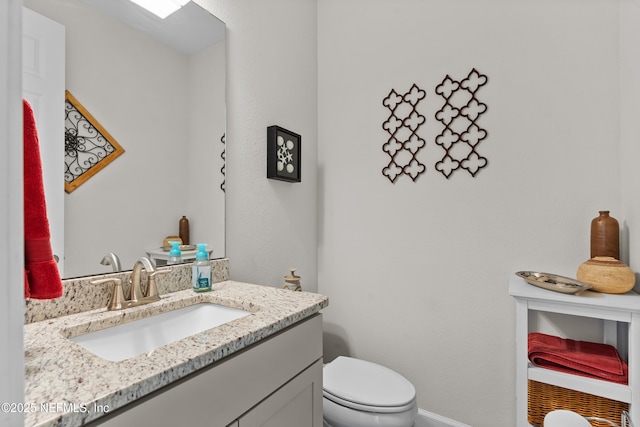 93322 Sandown Dr, Fernandina Beach, FL 32034 - half bath featuring toilet, vanity, and baseboards