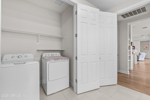 93322 Sandown Dr, Fernandina Beach, FL 32034 - laundry room with washing machine and clothes dryer, light tile patterned floors, and baseboards
