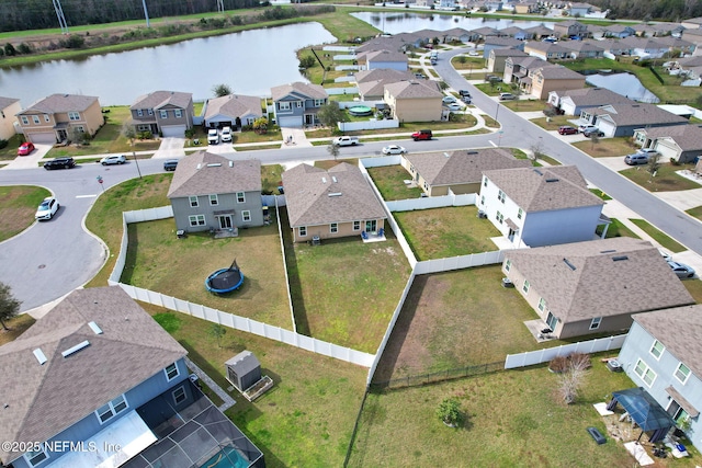 birds eye view of property with a water view and a residential view