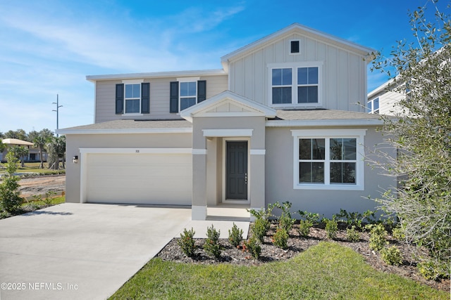 view of front of house with a garage, concrete driveway, a shingled roof, and board and batten siding