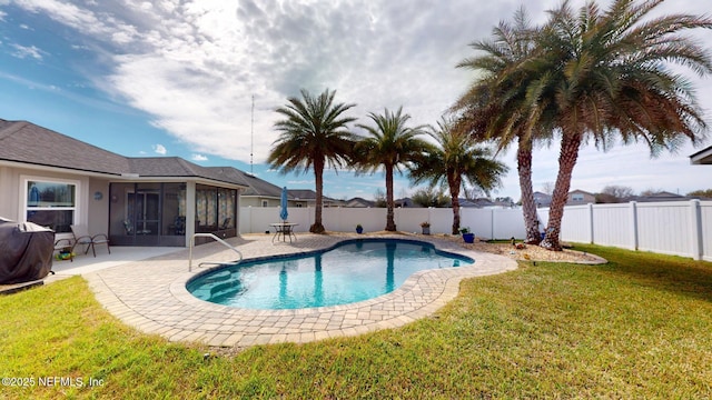 view of pool featuring a sunroom, a fenced backyard, a patio area, and a lawn