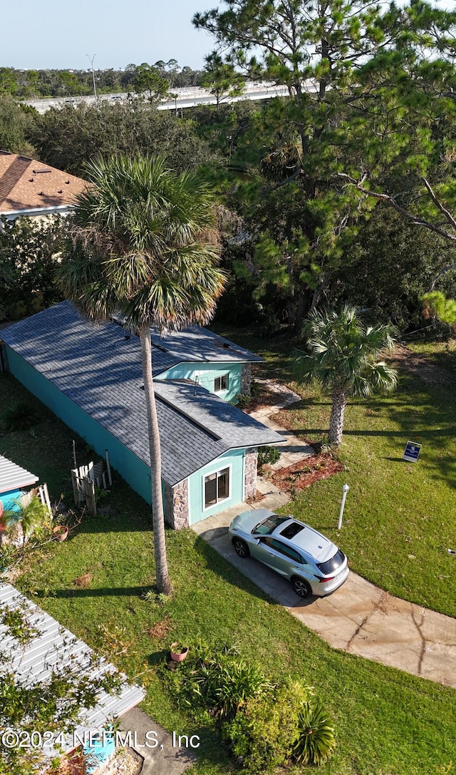 view of side of property with a lawn