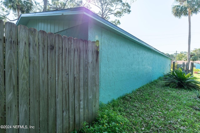 view of property exterior featuring fence and stucco siding