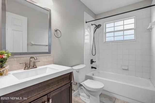 bathroom with shower / bath combination, toilet, and vanity