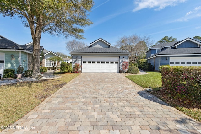 view of front of house featuring a front lawn and decorative driveway