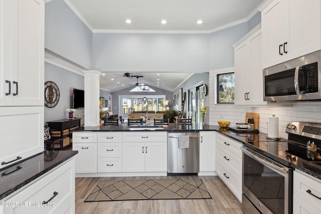 kitchen with ceiling fan, stainless steel appliances, a sink, white cabinetry, and crown molding