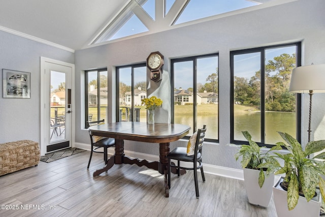 interior space featuring lofted ceiling and a water view