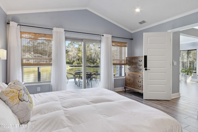 bedroom featuring crown molding, visible vents, vaulted ceiling, and wood finished floors