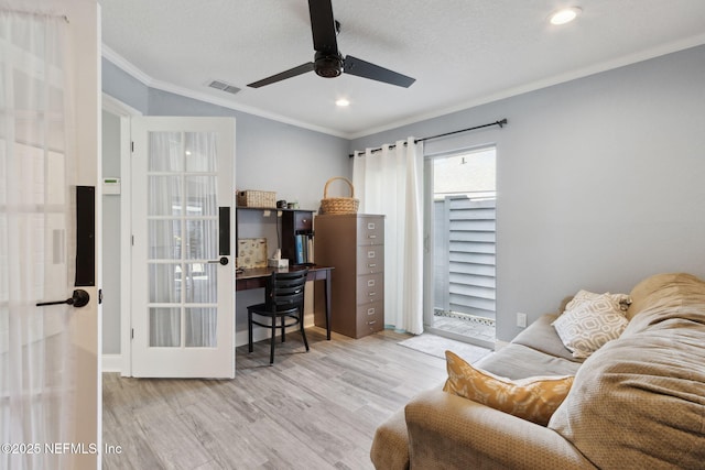 office area with a textured ceiling, wood finished floors, a ceiling fan, french doors, and ornamental molding