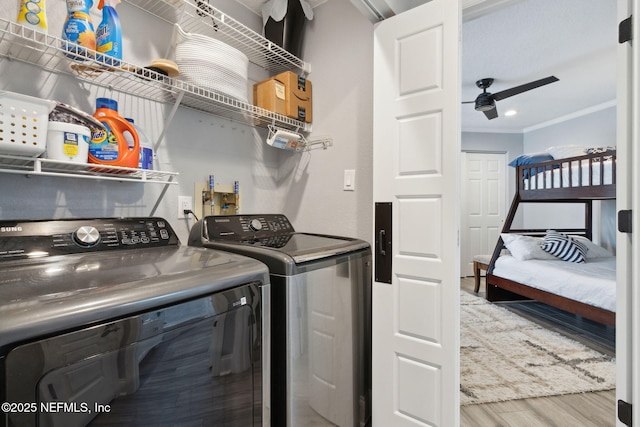 washroom featuring laundry area, a ceiling fan, wood finished floors, independent washer and dryer, and crown molding