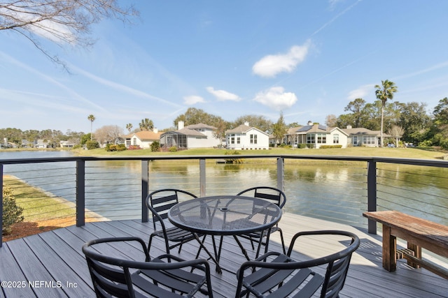 deck with a residential view and a water view