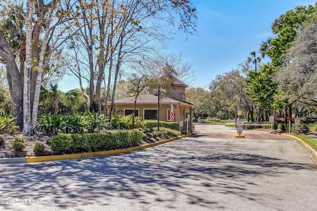 view of street featuring curbs and a gated entry