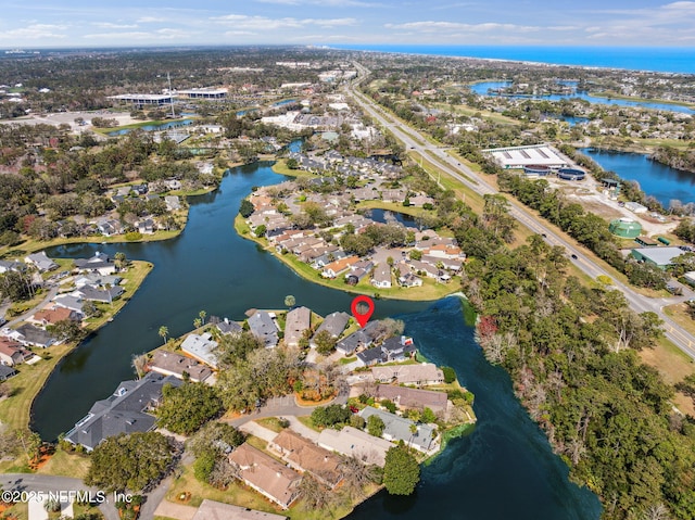 birds eye view of property with a water view and a residential view