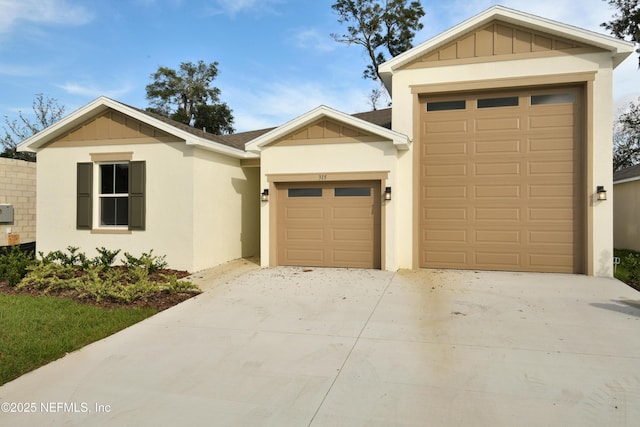 single story home with a garage, board and batten siding, concrete driveway, and stucco siding