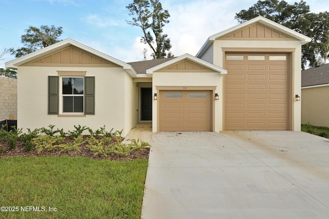 ranch-style house featuring a garage, board and batten siding, a shingled roof, and concrete driveway