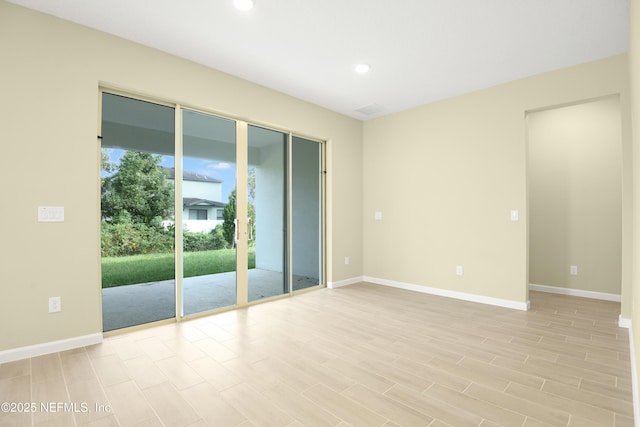 unfurnished room with light wood-style floors, baseboards, and recessed lighting