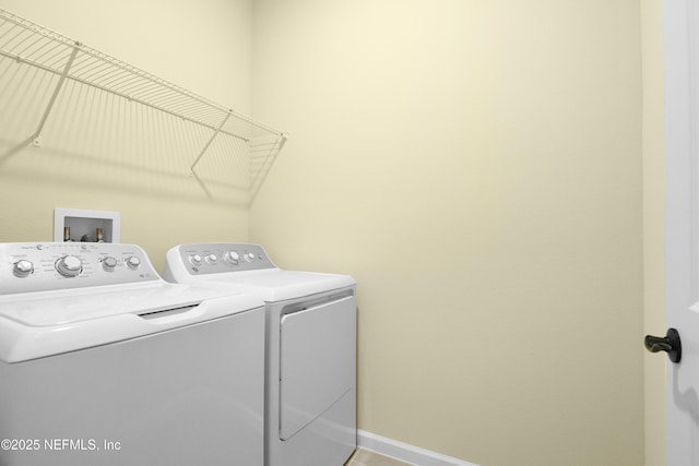 laundry room with laundry area, baseboards, and washing machine and clothes dryer