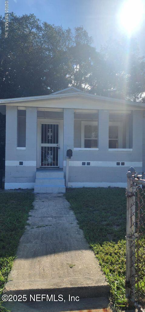 view of exterior entry with a yard and crawl space