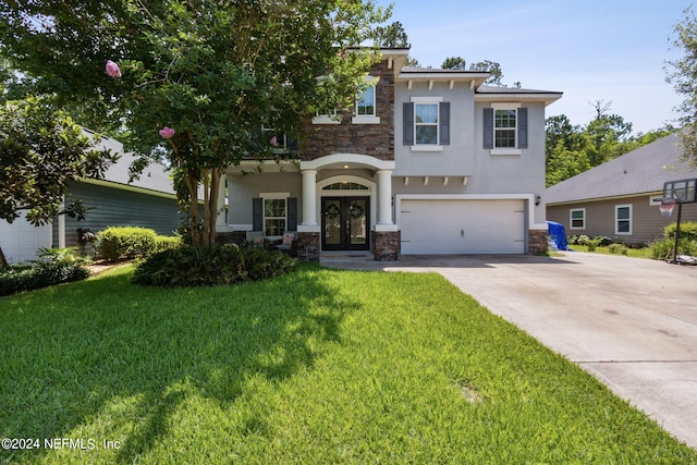 view of front of property featuring a garage, stone siding, french doors, concrete driveway, and a front lawn