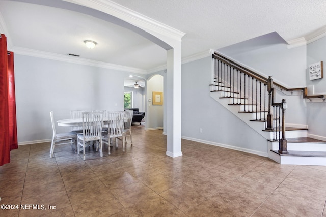 dining room with visible vents, arched walkways, baseboards, stairway, and ornamental molding