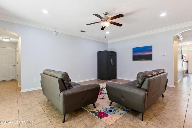 living room featuring arched walkways, ornamental molding, light tile patterned floors, and visible vents