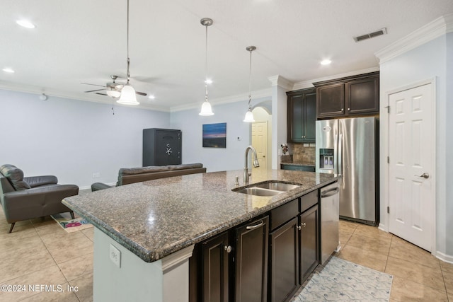 kitchen with stainless steel appliances, visible vents, ornamental molding, open floor plan, and a sink