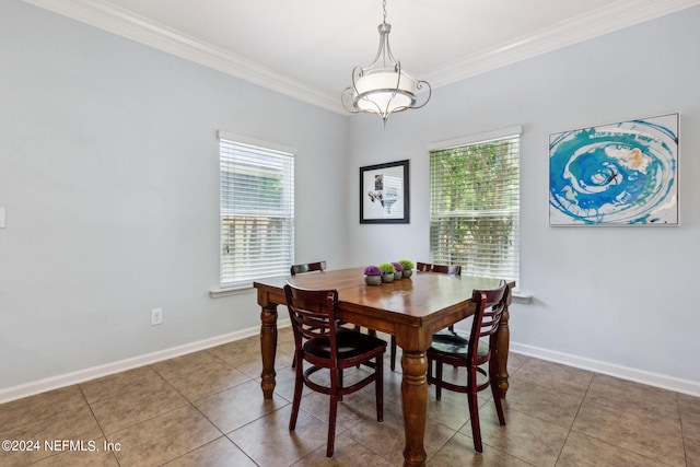 tiled dining area featuring ornamental molding and baseboards