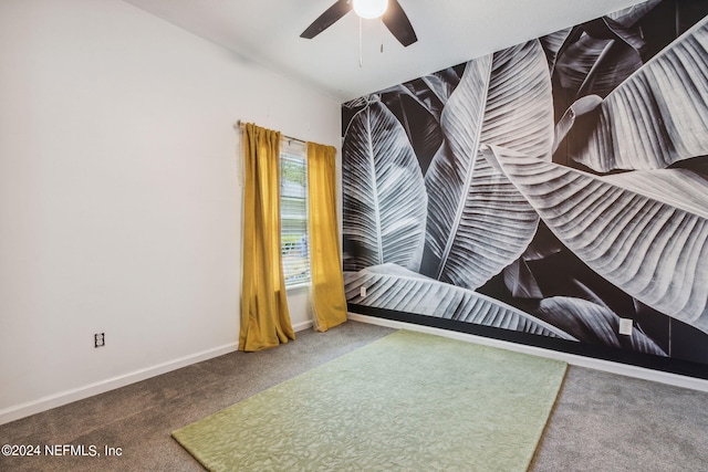 unfurnished bedroom featuring carpet, a ceiling fan, and baseboards