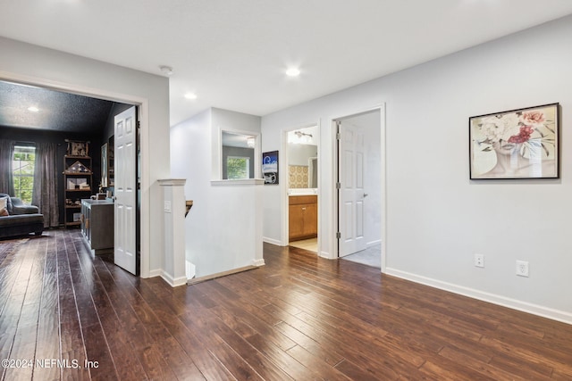 empty room featuring recessed lighting, baseboards, and hardwood / wood-style flooring