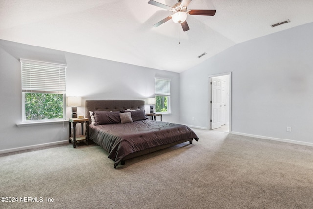 carpeted bedroom with a ceiling fan, visible vents, vaulted ceiling, and baseboards