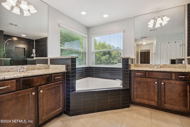 bathroom featuring a garden tub, visible vents, a sink, tile patterned flooring, and tiled shower