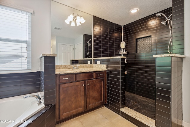 full bath with visible vents, a garden tub, tile patterned flooring, a textured ceiling, and a walk in shower