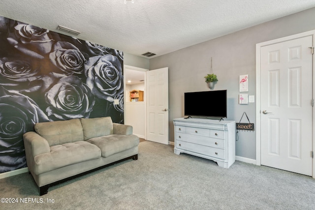 carpeted living room with visible vents, a textured ceiling, and baseboards