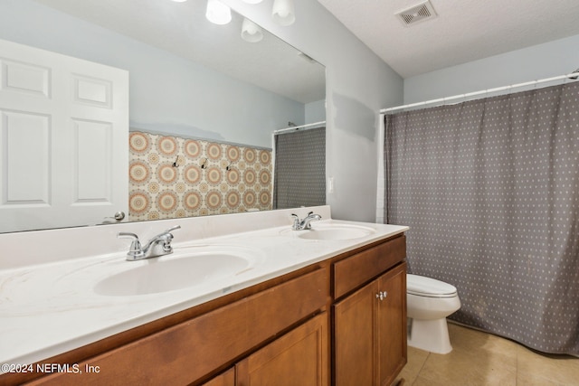 full bath featuring toilet, visible vents, a sink, and tile patterned floors