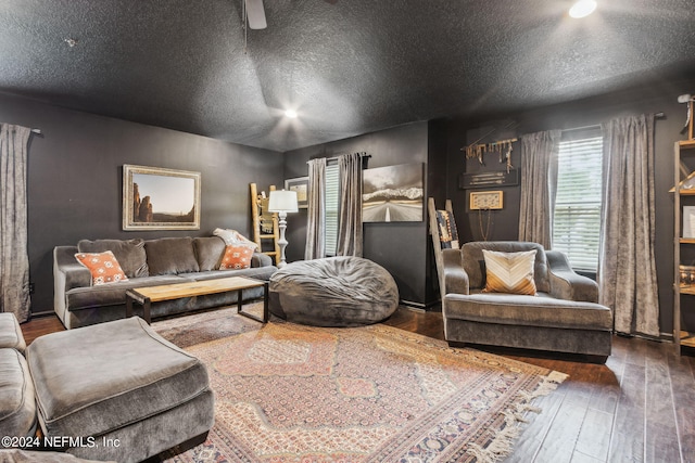 living area with a textured ceiling and wood-type flooring