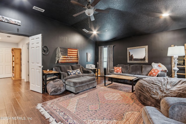 living room with visible vents, vaulted ceiling, a textured ceiling, and wood finished floors