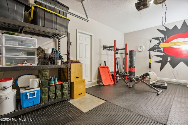 workout room featuring a garage, a textured ceiling, and baseboards