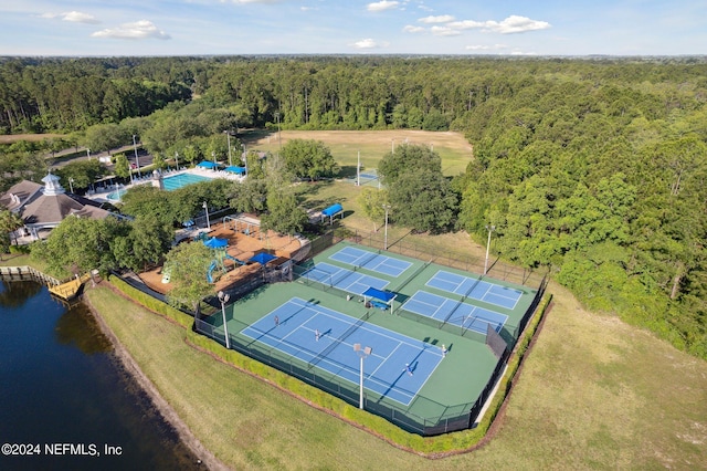 aerial view with a water view and a wooded view