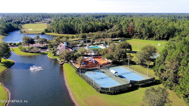 birds eye view of property with a water view and a wooded view